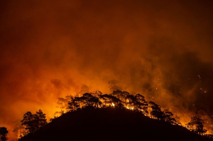 Marmaris on the Aegean Sea saw flames simmer across the crests of forest-covered hills as Turkey fights deadly wildfires