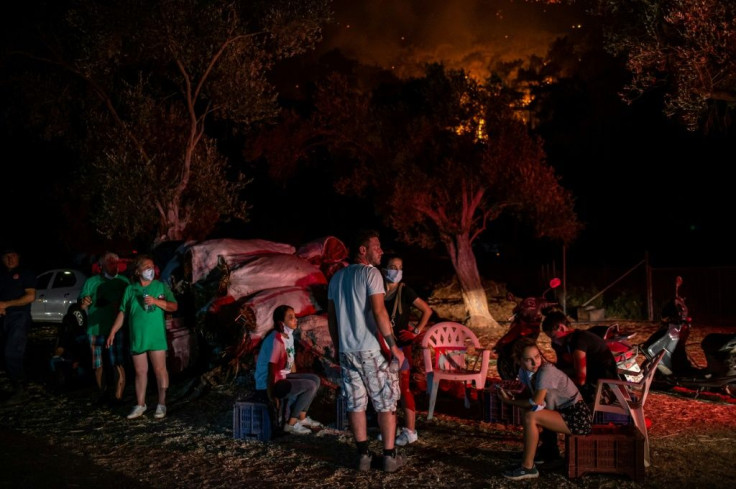 The night sky glowed amber and the smoke-filled air was heavy and hard to breathe in stifling heat in Marmaris