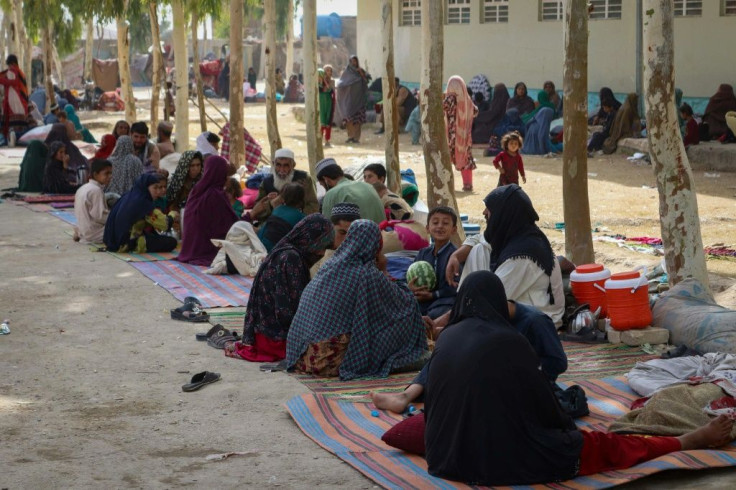 Afghan internally displaced families arrive in Kandahar as they flee battles between Taliban fighters and Afghan security forces on July 27, 2021