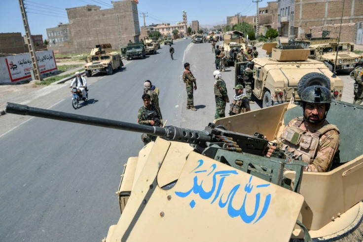 An Afghan National Army commando stands guard on top of a vehicle in Herat province amid skirmishes with the Taliban