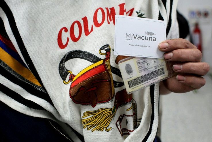 A man shows a vaccination certificate after receiving a dose of Sinovac Covid-19 vaccine in Sumapaz, Bogota's rural zone on July 29, 2021.