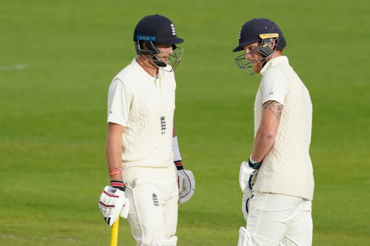 England's Joe Root (L) chats with Ben Stokes (R)