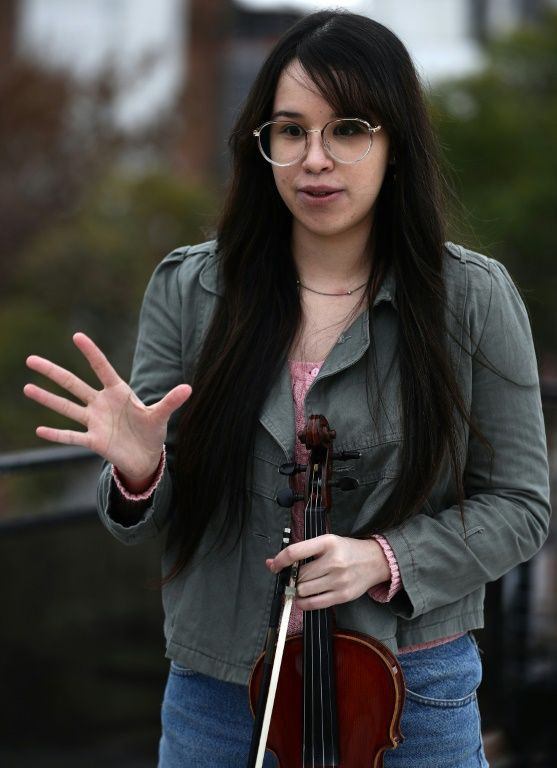 Violinist Maria Andreyna Chavez says the orchestra's rehearsals have been a "blessing" for the Venezuelan members