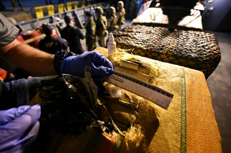 An official in Colombia inspects packages with cocaine on a seized submarine in the city of in Buenaventura on March 20, 2021