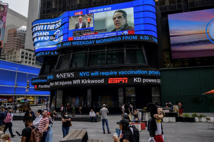 A screen shows news coverage of New York Governor Andrew Cuomo following revelations over allegations of sexual harassment, in Times Square on August 3, 2021