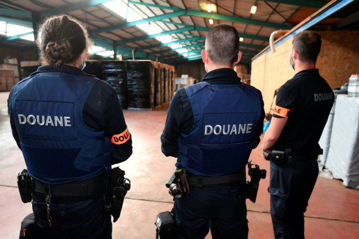 Customs officers inspect an illegal cigarette smuggling site in Aartselaar, near Antwerp