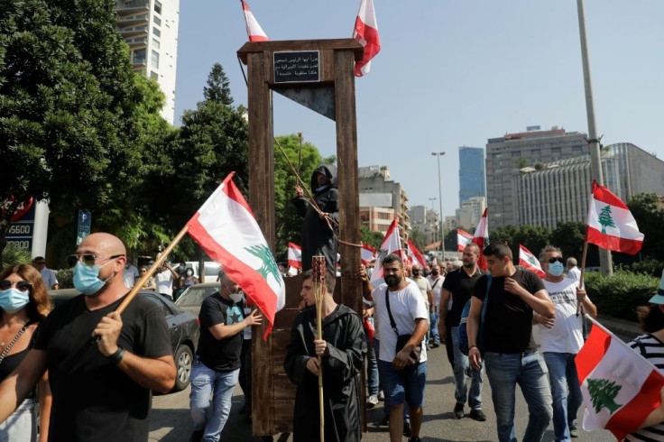 Demonstrators in the Lebanese capital march with a guillotine device