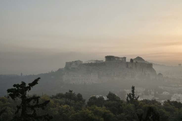 Smoke sits over the Acropolis in Athens from a forest fire raging near the Greek capital