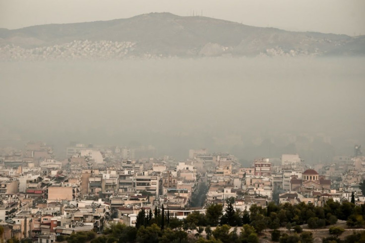 The centre of Athens is covered in smoke as fires rage nearby