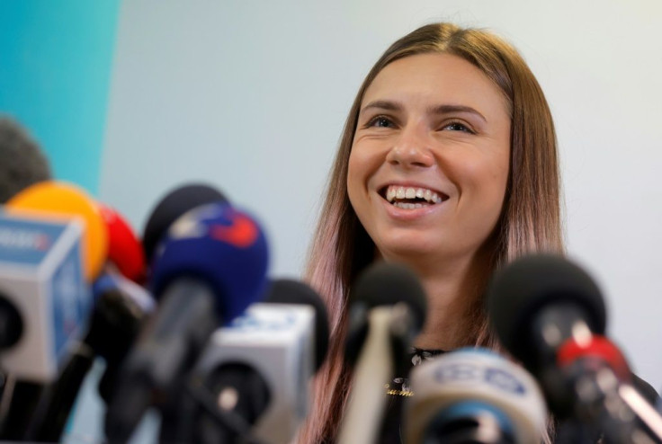 Belarusian Olympic athlete Krystsina Tsimanouskaya laughs as she addresses a press conference on August 5, 2021 in Warsaw, one day after her arrival in Poland