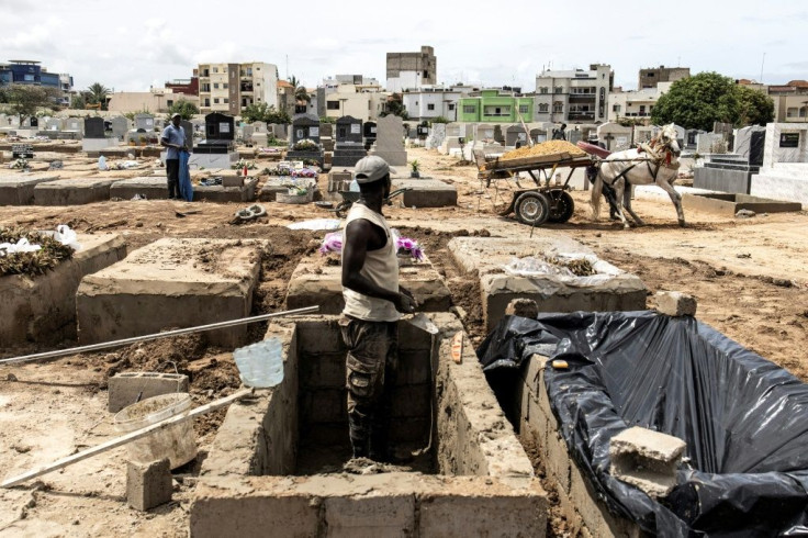 Funeral workers in many nations, including this one in Senegal's Dakar, have been busy with the mounting Covid bodies