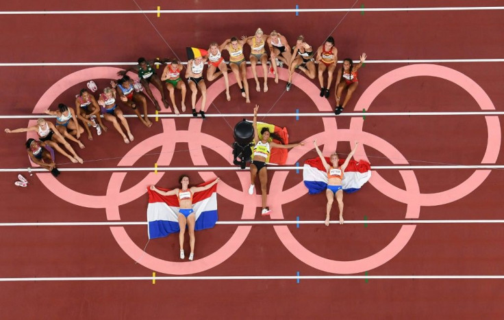 Gold medallist Belgium's Nafissatou Thiam lies at the centre of the exhausted heptathlon field