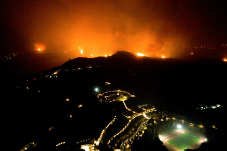 A wildfire approaches the Olympic Academy in ancient Olympia in western Greece on August 4, 2021