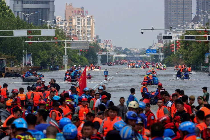 Rescuers evacuating residents at a flooded area in Weihui, Xinxiang city, in China's central Henan province