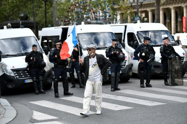 Protesters in Paris on Thursday chanted slogans "libery, liberty" and "Macron, we don't want your pass"