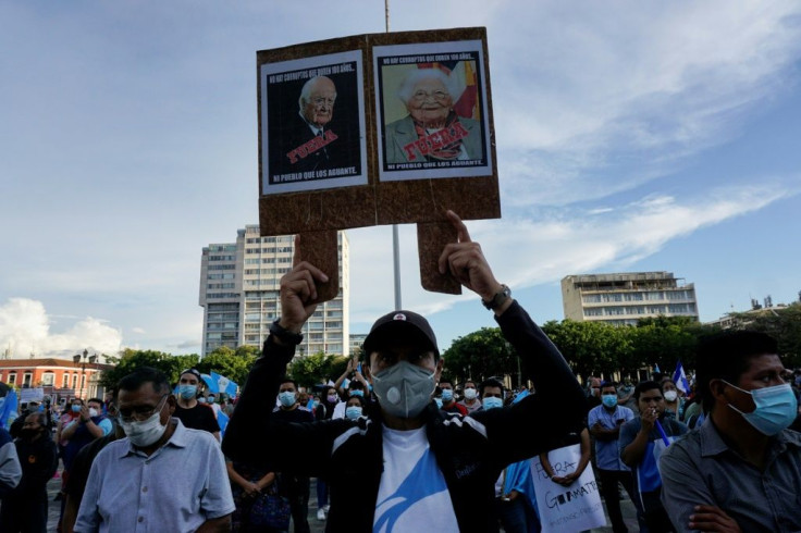 A demonstrator demands the resignation of Guatemala's President Alejandro Giammattei and Attorney General Maria Consuelo Porras after the dismissal of the special prosecutor for corruption in July 2021