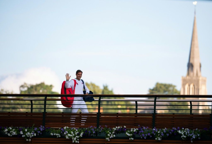 Final farewell?: Roger Federer waves to fans as he walks across the players bridge after losing in the Wimbledon quarter-finals last month