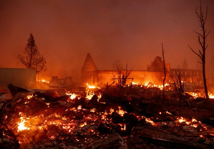 Buildings burn as the Dixie Fire tears through downtown Greenville, California on August 4, 2021