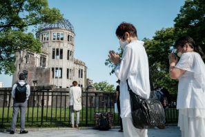 People offer prayers by the Atomic Bomb Dome in Hiroshima