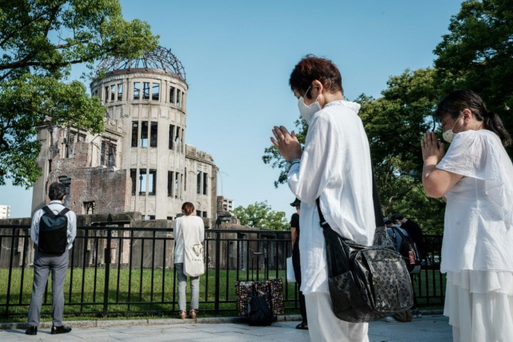 People offer prayers by the Atomic Bomb Dome in Hiroshima