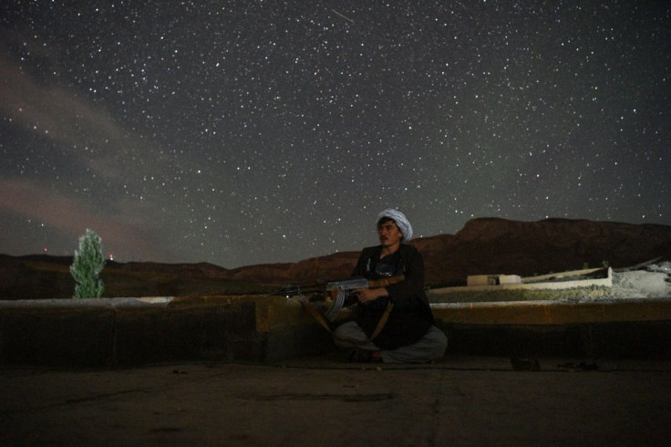 A member of Mazari's volunteer force keeps watch against a backdrop of a starry sky in Charkint district, northern Afghanistan
