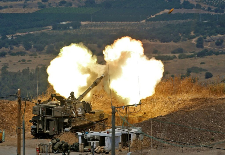 Israeli self-propelled howitzers fire towards Lebanon from a position near the northern Israeli town of Kiryat Shmona
