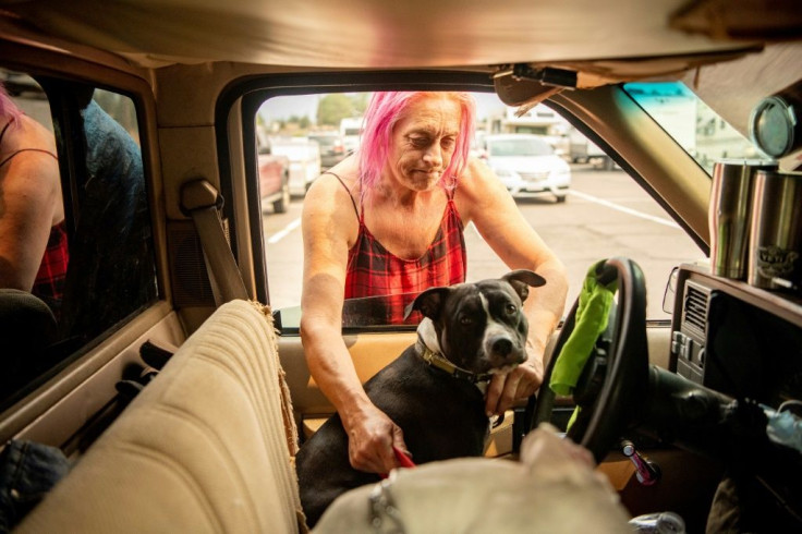 Regina Rutledge and her dog are now at an evacuation center after fleeing the Dixie Fire