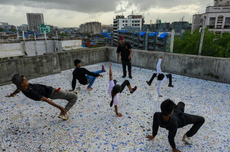 After the slum -- India's largest -- defeated the pandemic, some of its young residents pulled out their phones to write, shoot and release a triumphant rap video