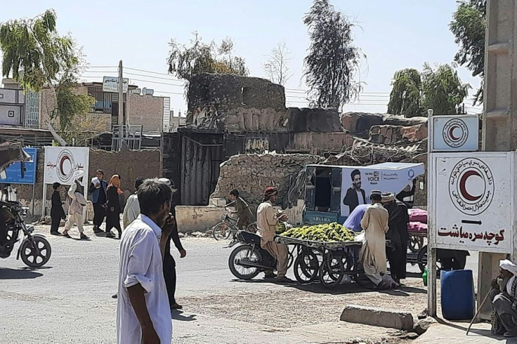 A vendor sells fruit in Zaranj, capital of Nimroz province, a day after the city fell to the Taliban
