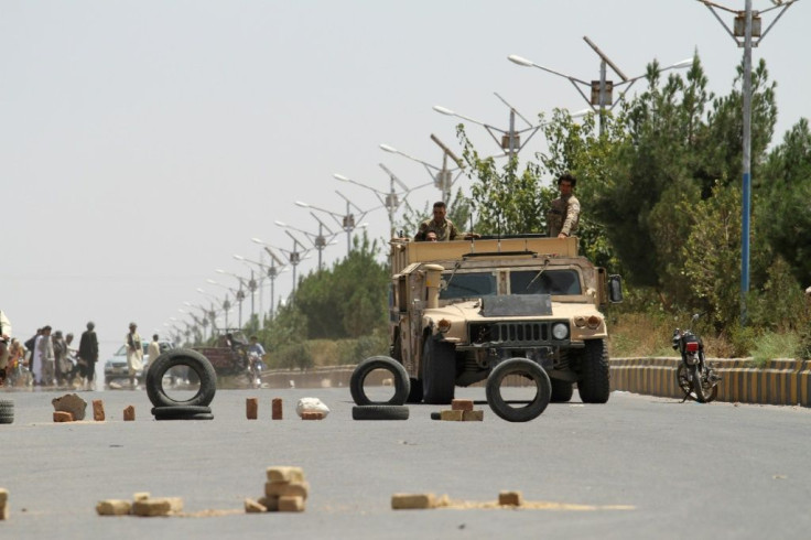 Afghan security personnel on patrol on the outskirts of Herat, which is currently under attack by Taliban insurgents