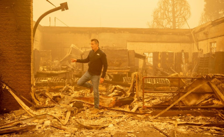 California Governor Gavin Newsom surveys a United States Post Office that burned down in downtown Greenville in the Dixie fire -- now the state's second-largest ever