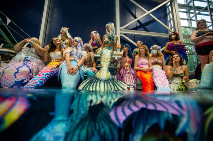 Midday at the aquatic center saw several hundred merfolk perched on the edge of the large pool for a group photo and an open water swim