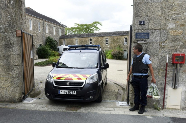 A French polic vehicle leaves the place where a French Catholic priest, aged 60, was murdered in Saint-Laurent-sur-Sevres, western France