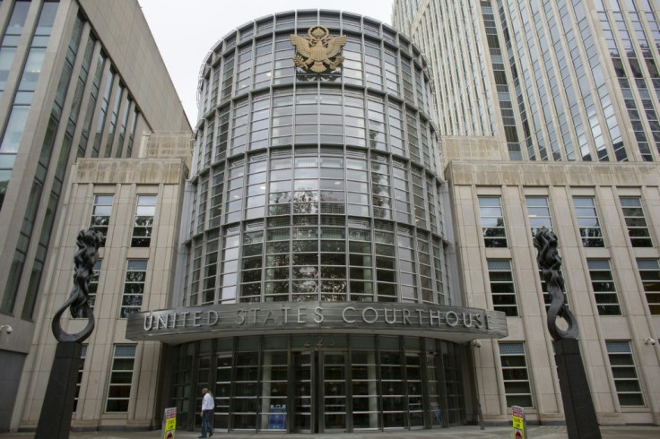 People walk in front of the Brooklyn federal court where a hearing for the racketeering and sex trafficking case of R. Kelly is taking place in Brooklyn, New York on August 9, 2021