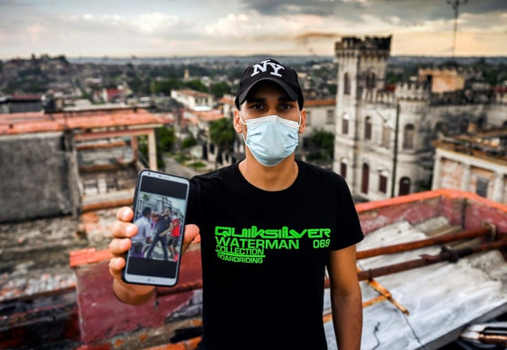 Rolando Remedios shows a photo on his telephone of the moment he was arrested during unprecedented anti-government protests in Cuba on July 11, 2021