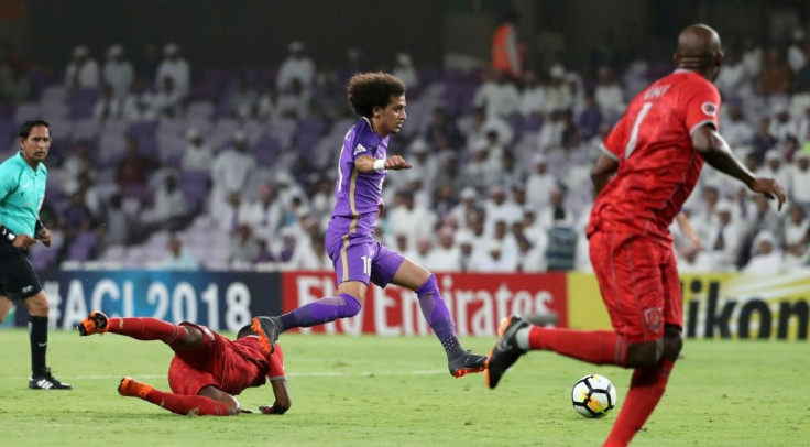 On the run: Al-Ain's Omar Abdulrahman (centre)