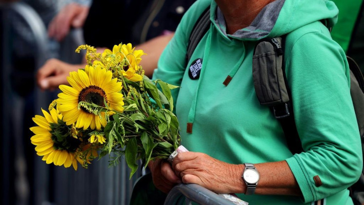 A Green party supporter holds a bouquet of flowers at the party's rally in Hildesheim, northern Germany