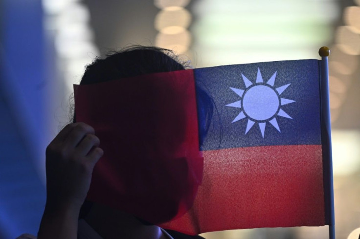 A woman holds a Taiwanese flag to mark the island's National Day. Beijing claims Taiwan as its own and has vowed to one day retake it -- by force if needed