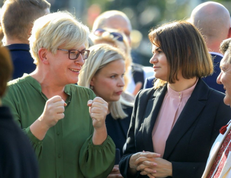 Belarusian opposition leader Svetlana Tikhanovskaya (right) and Lithuanian Prime Minister Ingrida Simonyte (left) talk as they take part in a demonstration in Vilnius