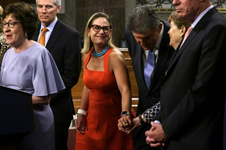 US Senator Kyrsten Sinema (center) was key in reaching bipartisan agreement on the $1.2 trillion infrastructure bill