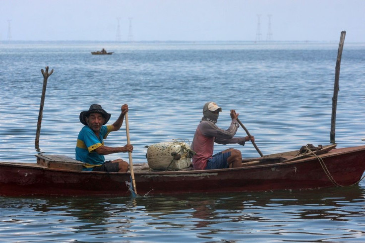 Fishermen on Lake Maracaibo often have to row their boats due to the fuel shortages