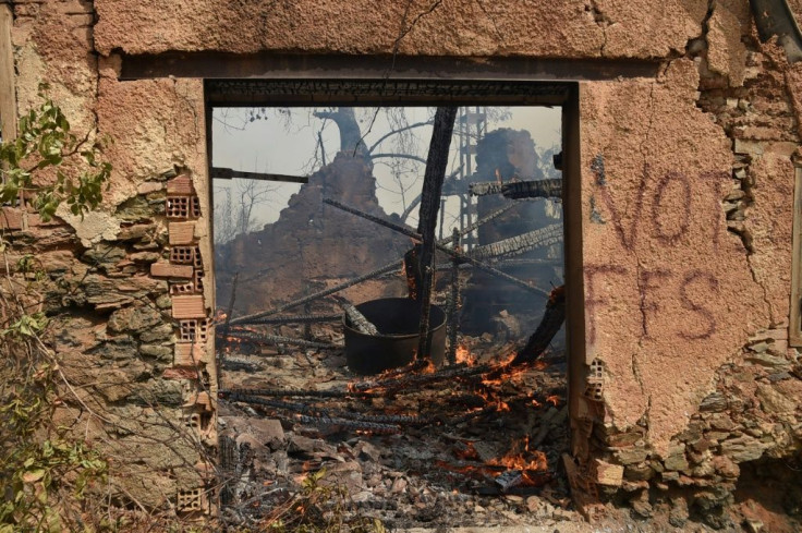 A house burns in a wildfire in Algeria's mainly Berber Tizi Ouzou district, east of the capital Algiers