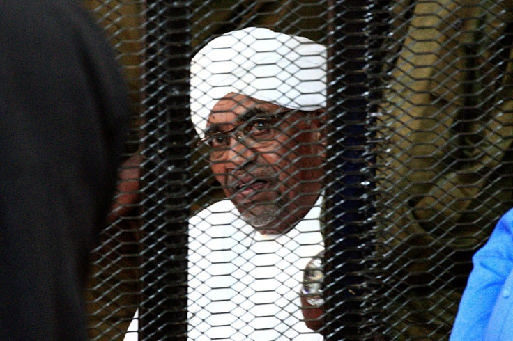 Sudan's deposed president Omar al-Bashir looks on from a defendant's cage during the opening of his corruption trial in Khartoum on August 19, 2019