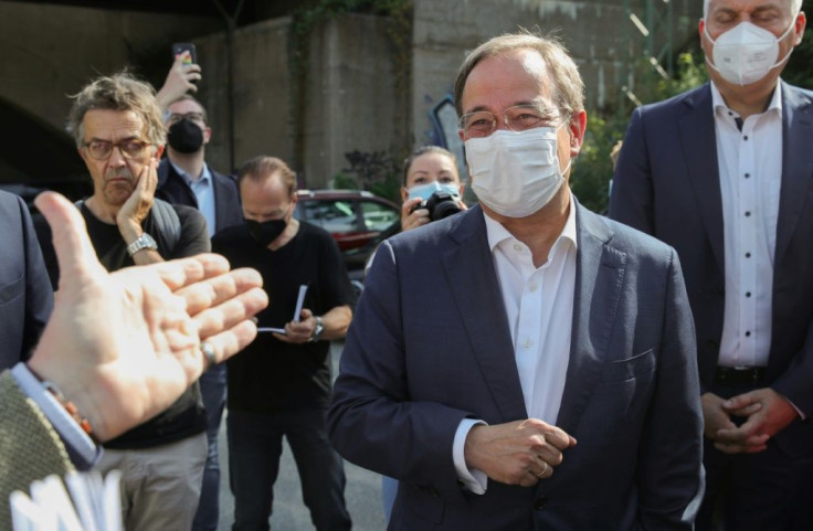Conservative CDU candidate Armin Laschet wears a face mask as he arrives for the election campaign meeting in Frankfurt