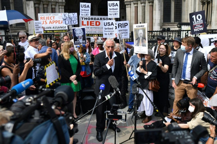 Veteran journalist John Pilger (centre) was among those who turned up to support Assange