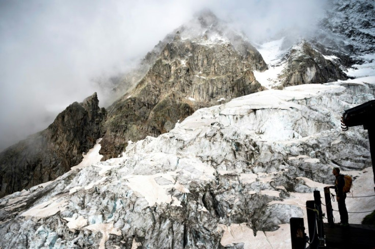 An alpinist stands on the balcony of the Boccalatte Hut on the Planpincieux Glacier in Courmayeur, north-western Italy