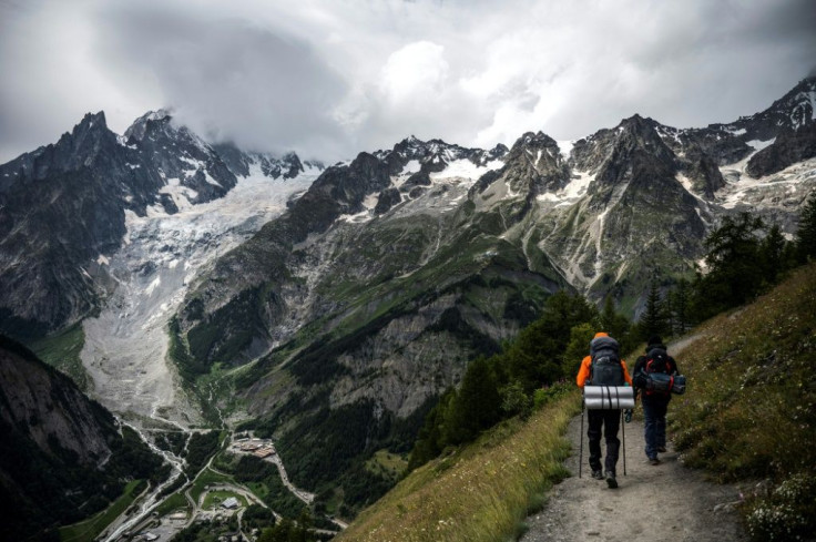 Hikers walk near the Brenva Glacier in Courmayeur, north-western Italy