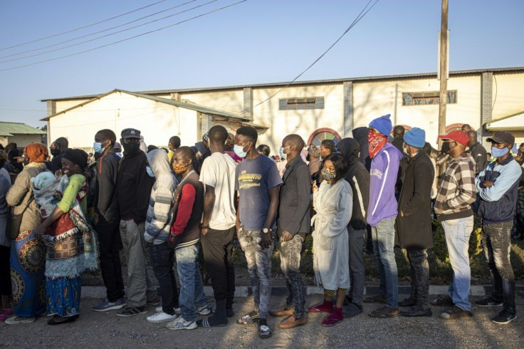 Queues of hundreds of people formed before dawn in front of voting stations in Lusaka