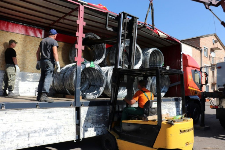 Razor wire coals are loaded on a truck in Ukraine, bound for Lithuania to help the country deter an influx of asylum seekers from Belarus