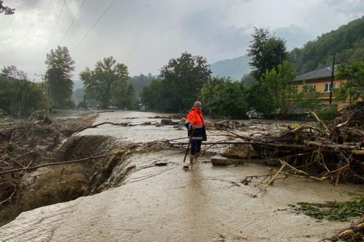 Heavy rains produced flash floods that turned streets into running rivers and sparked mudslides that buckled roads